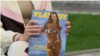 Ірина Білоцерковець тримає в руках журнал Playboy зі своєю фотографією на обкладинці